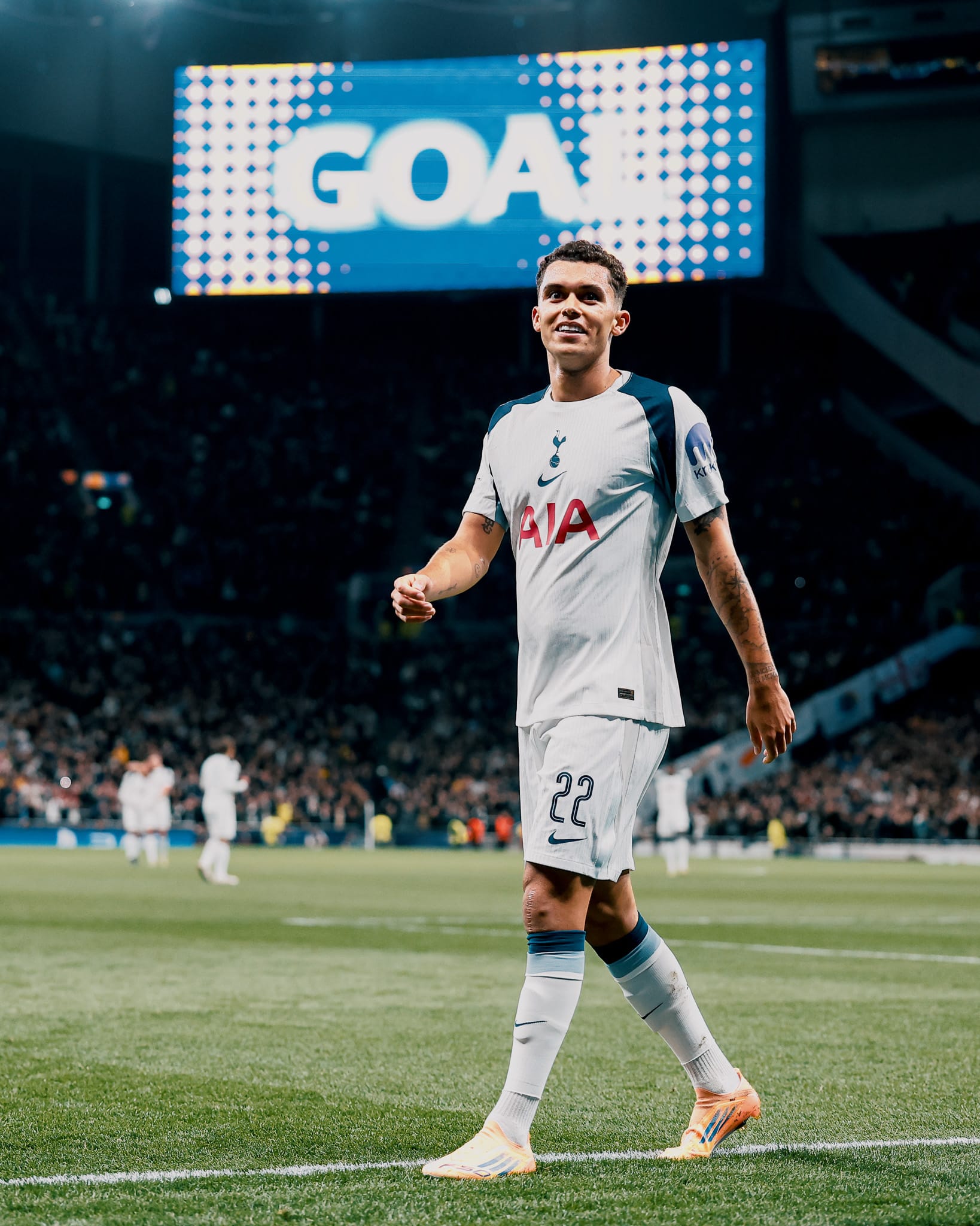 Brennan Johnson grins under the big screen flashing "GOAL"