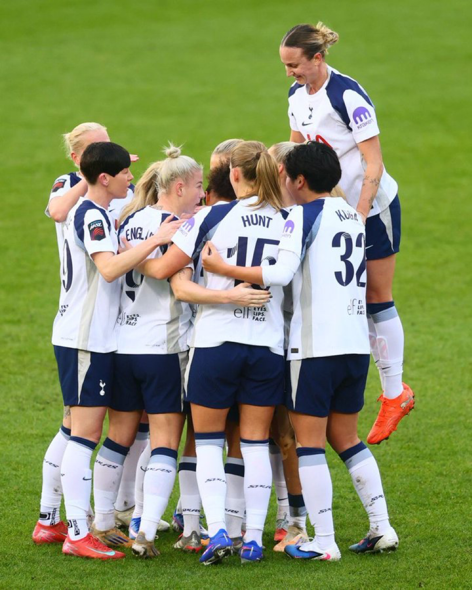 Martha Thomas jumps highest in the huddle of celebration for Drew Spence's goal.