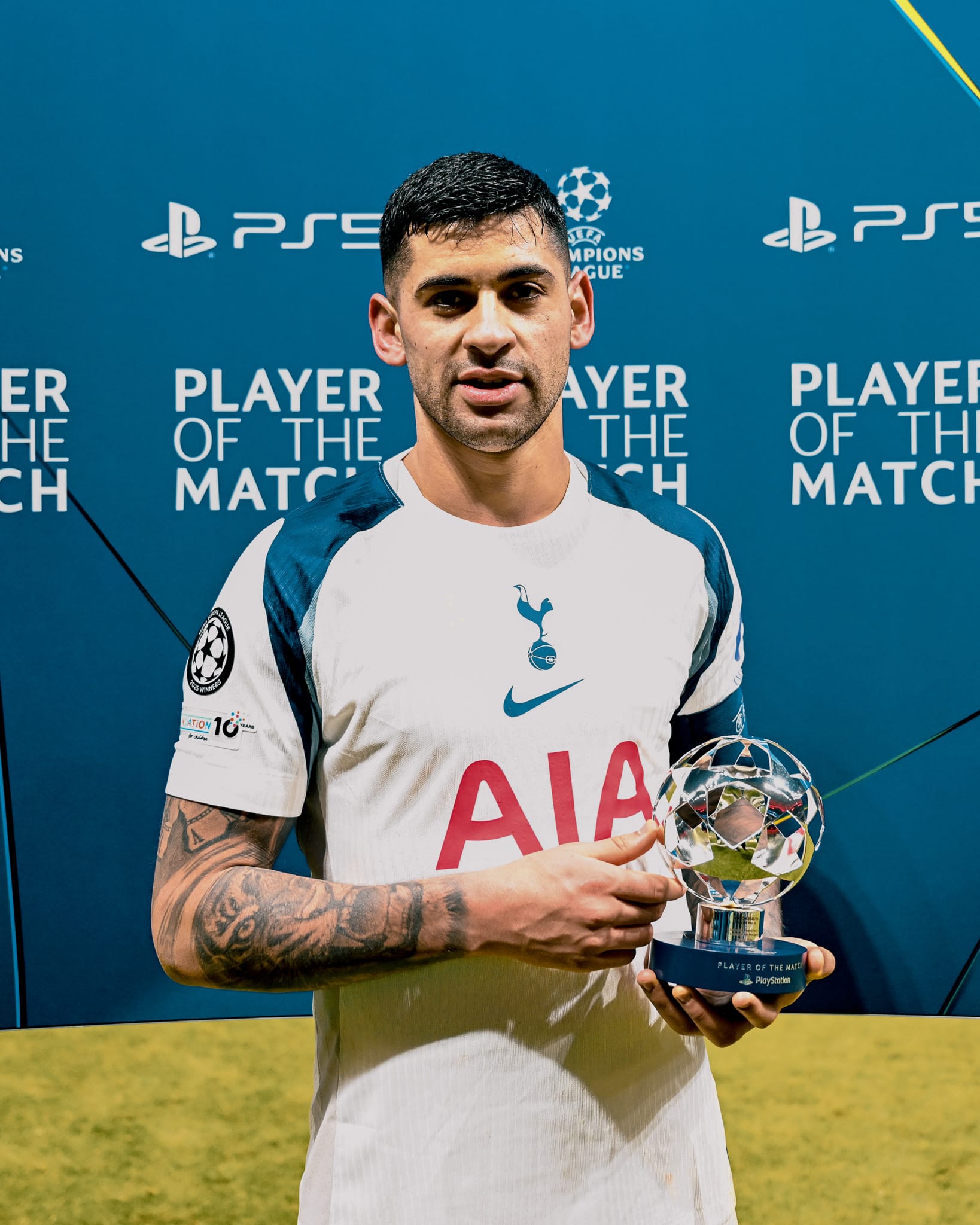 Cristian Romero holds his Player of the Match trophy.