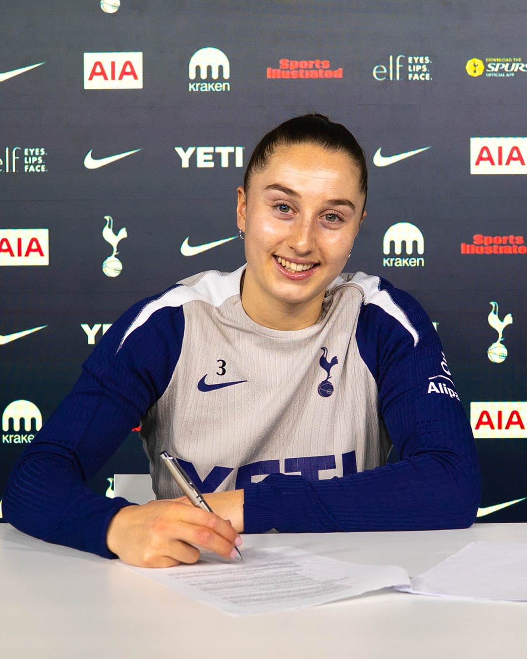 Ella Morris signs her contract extension.