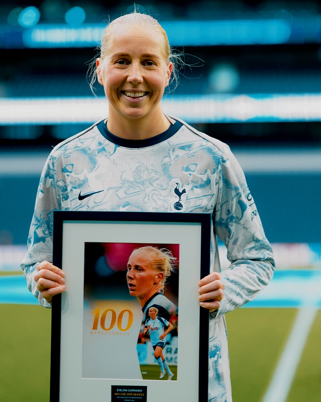 Eveliina Summanen holds up her 100 appearances commemorative gift from the club.