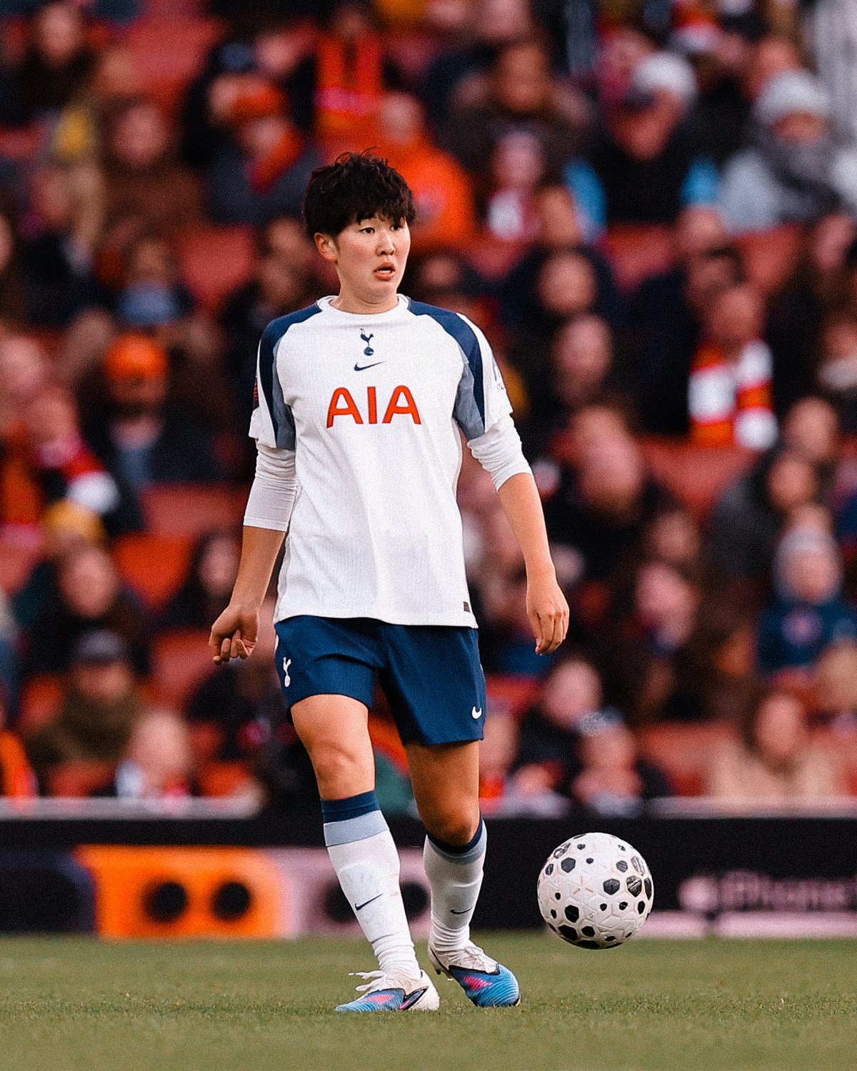 Tōko Koga scans the field with the ball at her feet.