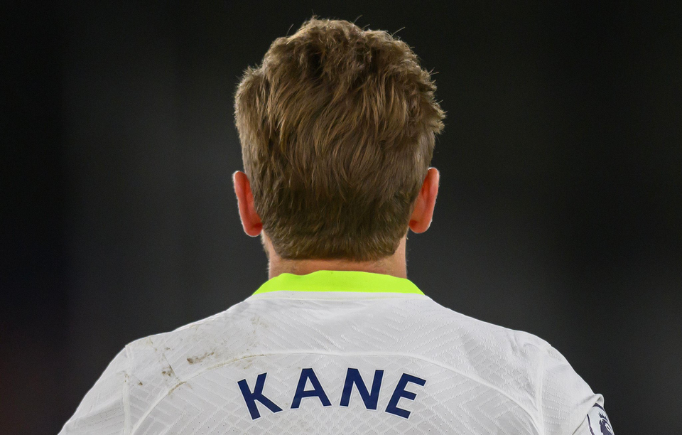 A photo of Harry Kane from behind, with his last name visible on his Spurs home shirt.