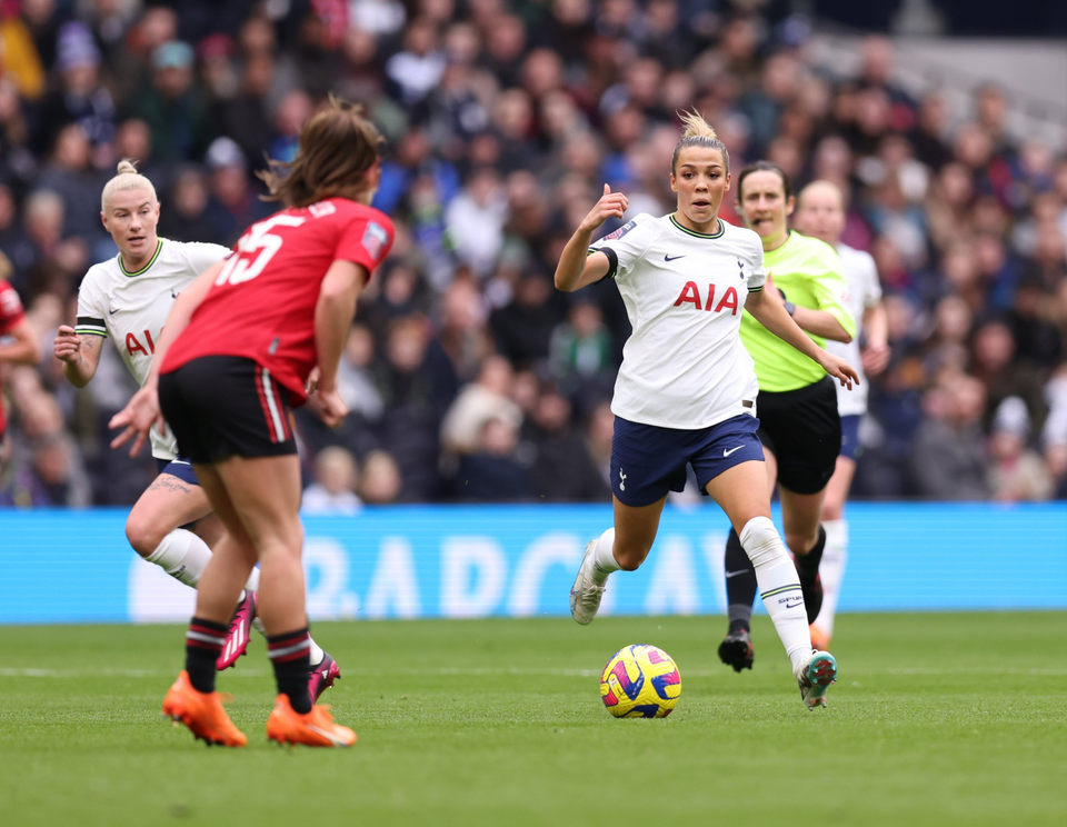 Celin Bizet dribbles past Maya Le Tissier as Beth England makes a run in the background.