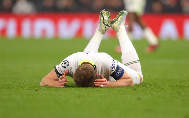 Harry Kane falls to the ground in frustration after missing a header.