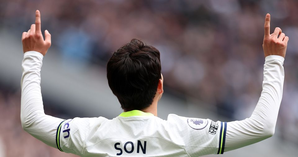 Son Heung-min celebrates a goal by pointing his hands to the sky.