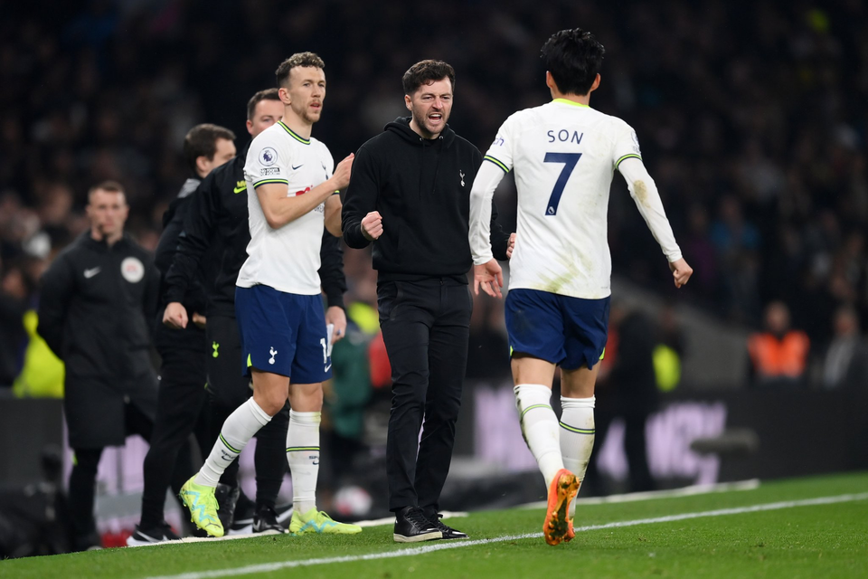 Son Heung-min runs to the touchline to celebrate his goal with returning interim manager Ryan Mason.