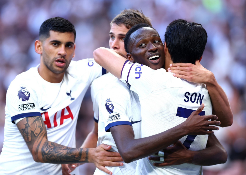 Pape Matar Sarr's teammates celebrate his goal with him.