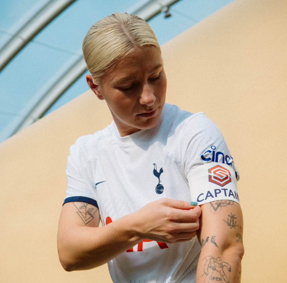 Beth England puts on the captain's armband.