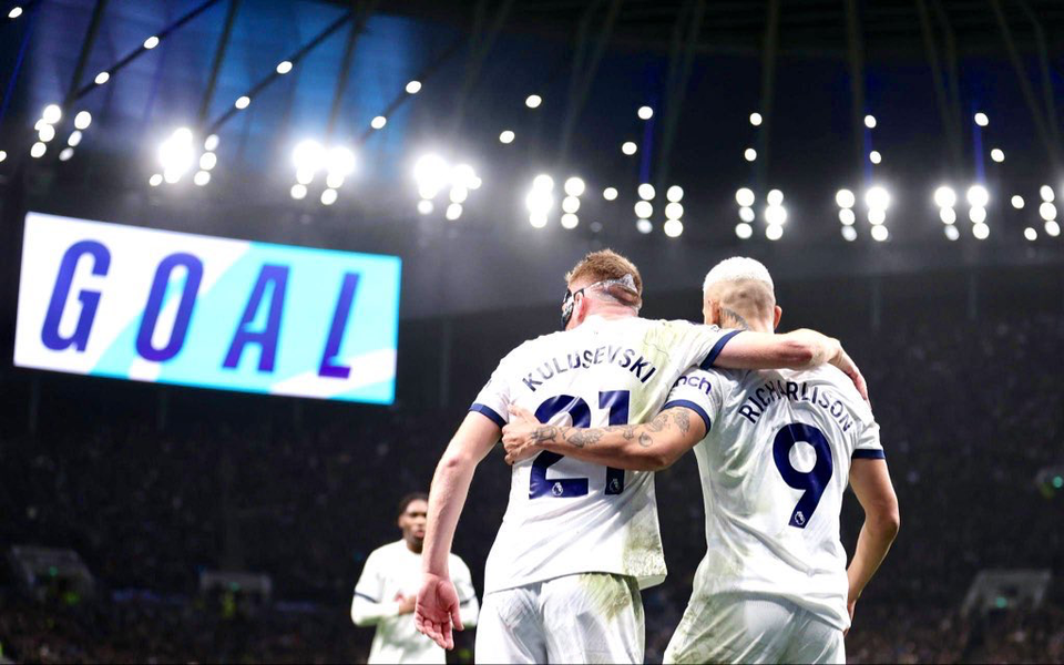 Dejan Kulusevski and Richarlison hug after the latter scores a goal. 