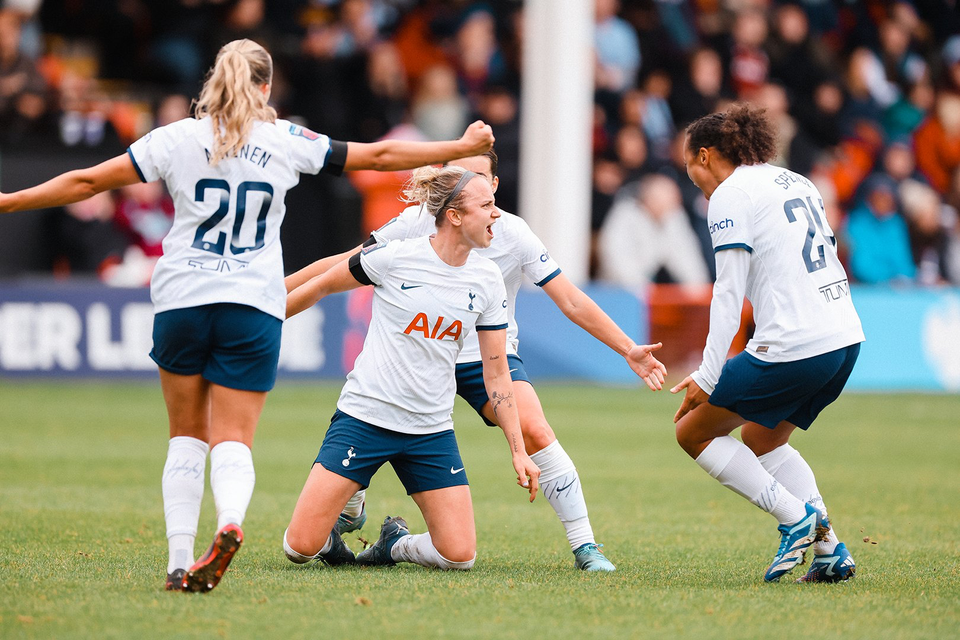 Martha Thomas celebrates a goal with her teammates.