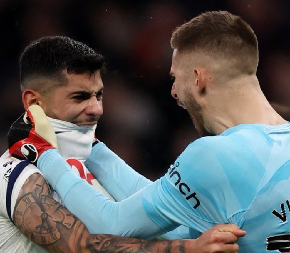 Guglielmo Vicario pulls Cristian Romero's shirt over his mouth as they celebrate the late win against Brighton.