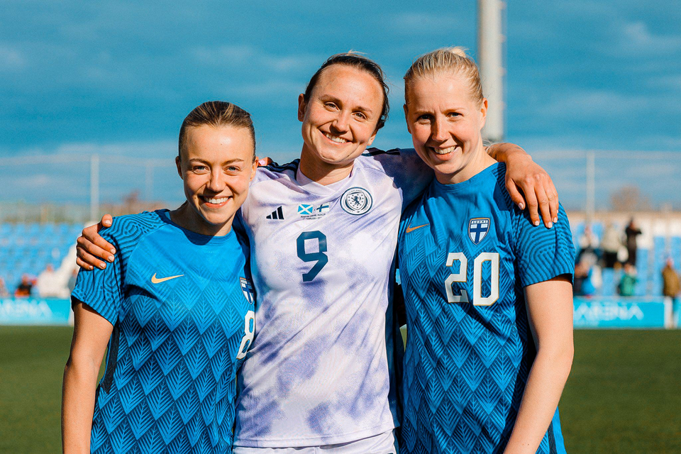 Martha Thomas stands in between Olga Ahtinen and Eveliina Summanen for a hug at the Pinatar Cup.