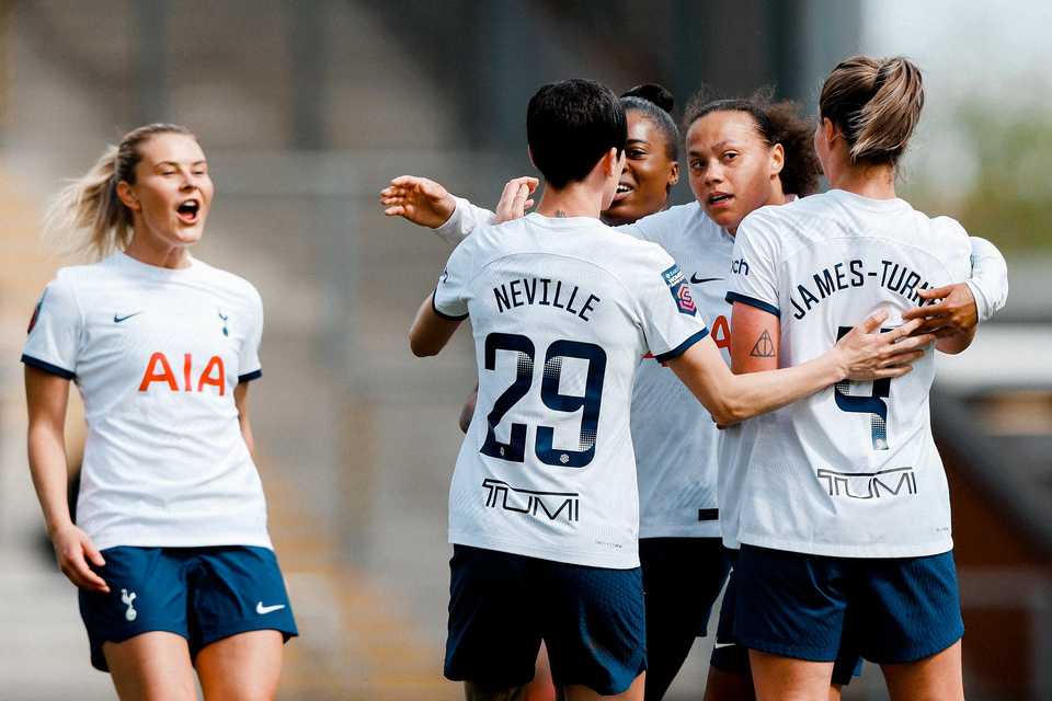 Amanda Nildén shouts as she approaches a cluster of players celebrating the equalizing goal.