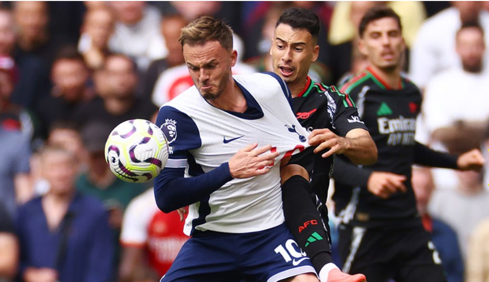 Gabriel Martinelli grabs James Maddison's shirt as they challenge for the ball. 