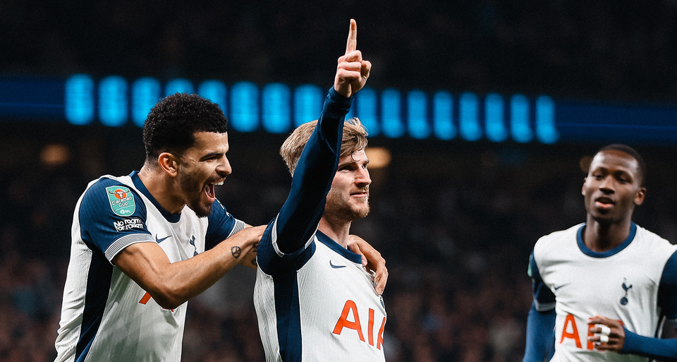 Timo Werner holds a finger up in the air as Dominic Solanke holds his shoulders and Pape Sarr approaches.