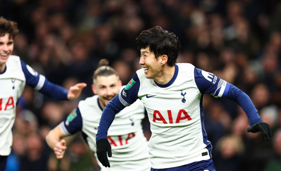 Son Heung-min celebrates a goal while his teammates run behind him.