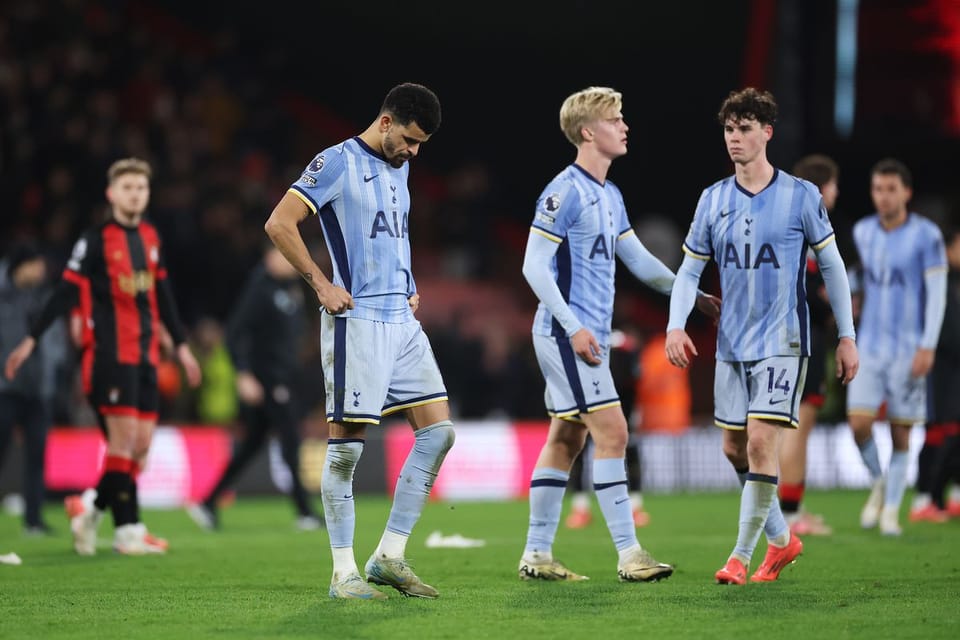 Dominic Solanke looks at the ground while two of his teammates walk by.