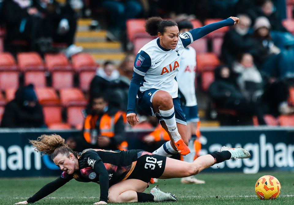 Drew Spence leaps over Ruby Mace to chase the ball.