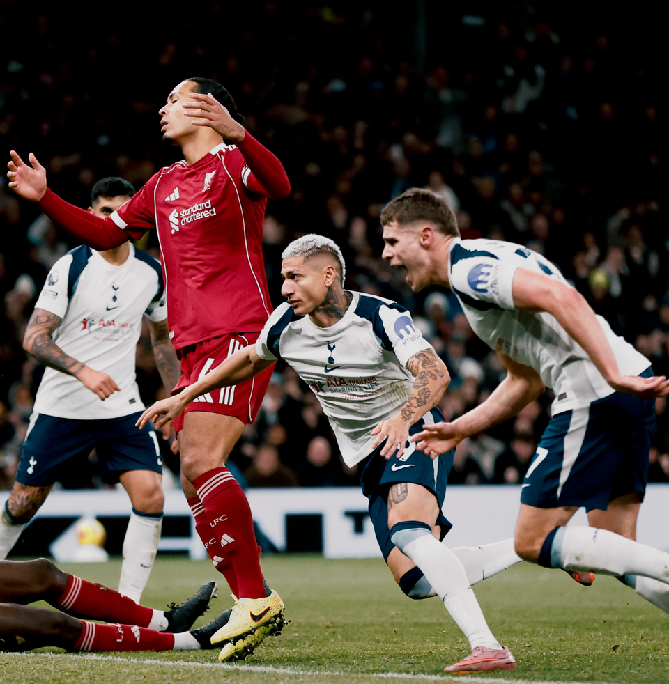 Richarlison wheels away to celebrate a goal while Virgil van Dijk throws his hands up beside him.