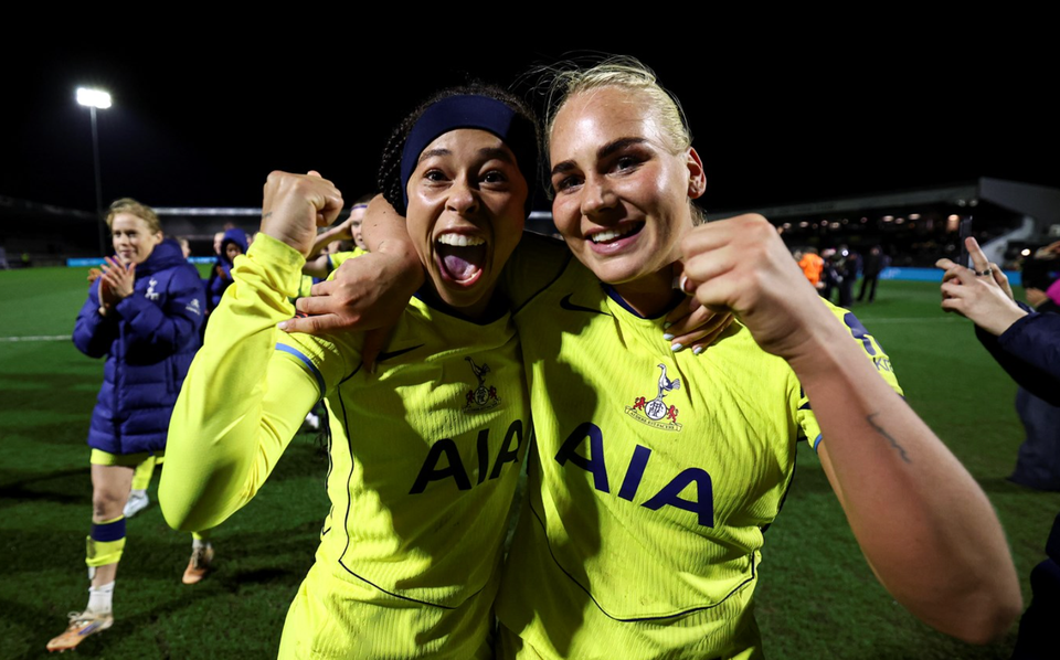 Lenna Gunning-Williams and Tinka Tandberg share a hug with fists raised.